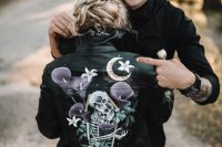 a black hand painted leather jacket with skeletons and a moody image will be a nice idea for a Halloween bride