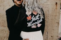 a black leather jacket accented with bold and fun heart appliques and calligraphy is a great idea for a modern fun wedding