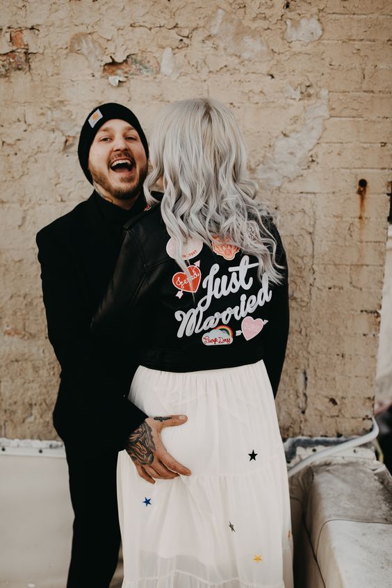 a black leather jacket accented with bold and fun heart appliques and calligraphy is a great idea for a modern fun wedding