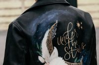 a black leather jacket painted for a celestial wedding, with blooms and a half moon is a gorgeous and romantic cove rup idea