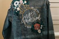 a bleached blue denim jacket with handpainting and colorful embroidery is a lovely idea for a boho bride