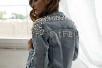 a blue denim Wifey jacket with lots of pearls covering the shoulders and the word done with pearls, too, for a tomantic look
