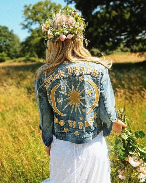 a blue denim jacket customized with yelow appliques to make its look boho and non-typical