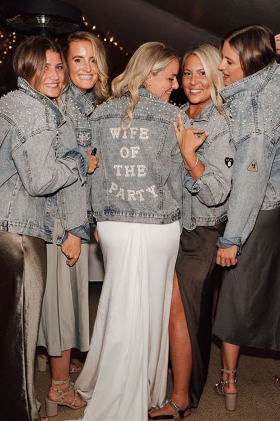 a blue denim jacket with letters and pearl embellished shoulders is a lovely idea for a boho bridal look
