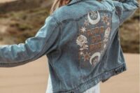 a blue denim wedding jacket customized with handpainting and appliques for a boho bride