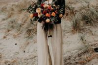 a blush wedding dress, a black hat and a black leather jacket for a stunning boho bridal look