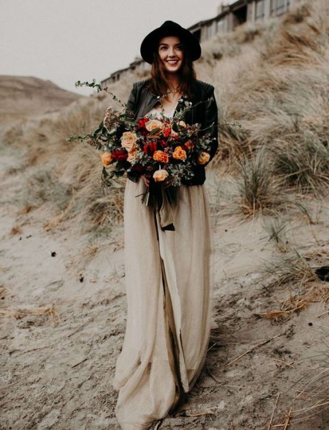 a blush wedding dress, a black hat and a black leather jacket for a stunning boho bridal look
