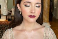 a bold and catchy shiny wedding makeup with shiny eyeshadow, bold berry lips and glowy skin is wow