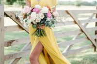 a bridesmaid wearing a yellow A-line maxi dress with a V-neckline, short sleeves and a slit plus a neutral and hot pink bouquet