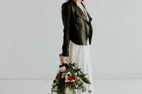 a modern bridal look with a chic front slit with a train and a black studded leather jacket