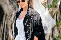 a oversized black denim bridal jacket with studs, crystal fringe is a trendy and edgy idea for a rock-n-roll bride