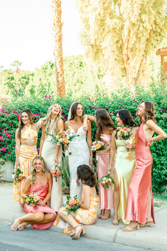 colorful bridesmaid dresses including blush, pink and yellow ones, with and without prints for a tropical wedding