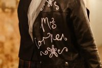 customize your black leather jacket with white calligraphy and blooms to make it ultimate and pair it up with your wedding dress