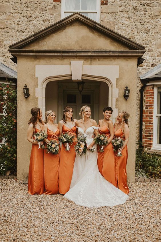 elegant matching maxi orange sating bridesmaid dresses with draped bodices and spaghetti straps are pure chic