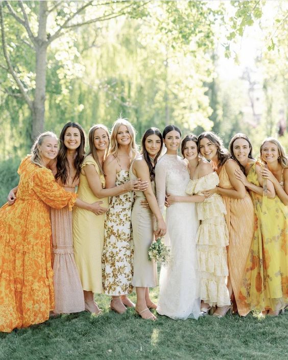 lovely mismatching yellow, marigold and blush bridesmaid dresses with various prints and detailing are amazing
