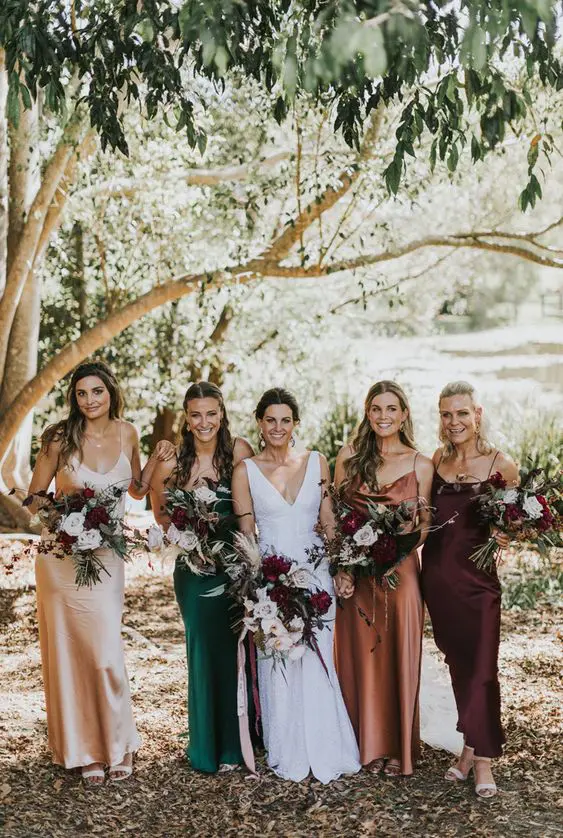 matching maxi bridesmaid dresses in the fall shades - amber, creamy, green and brown plus nude shoes for a fall wedding