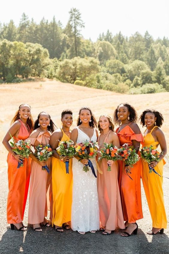 mismatched orange, blush and yellow maxi bridesmaid dresses for a colorful summer wedding