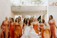 mismatching bridesmaid dresses in all shades of orange are a very trendy and edgy idea