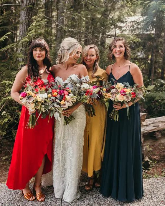 mismatching jewel tone midi and maxi bridesmaid dresses in red, mustard and dark green are amazing for a bright fall wedding