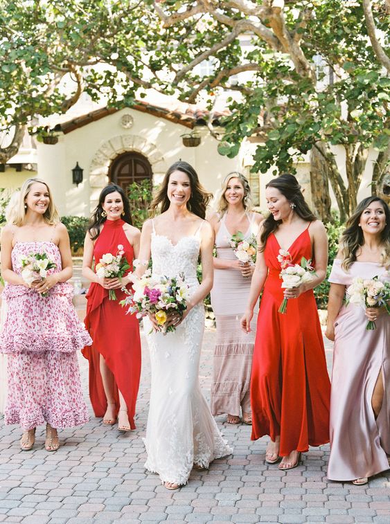 mismatching lilac, pink and orange maxi bridesmaid dresses, with and without prints for a lively summer wedding