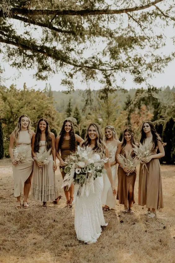mismatching off-white, greige and brown midi bridesmaid dresses for a neutral boho wedding