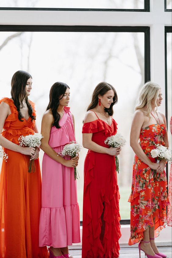 mismatching orange and pink maxi and midi bridesmaid dresses with ruffles and floral prints for a chic and cute bridal party look