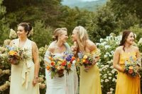 mismatching pale, bright and bold yellow midi bridesmaid dresses for a spring or summer wedding