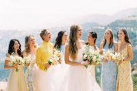 mismatching pastel blue and yellow printed and non-printed bridesmaid dresses of maxi length are adorable