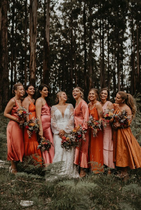 mismatching pink, orange and mustard satin maxi and midi bridesmaid dresses for a wedding with such a color scheme