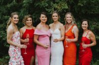 mismatching pink, ored, orange and floral midi and knee bridesmaid dresses for a trendy mismatched bridal party look