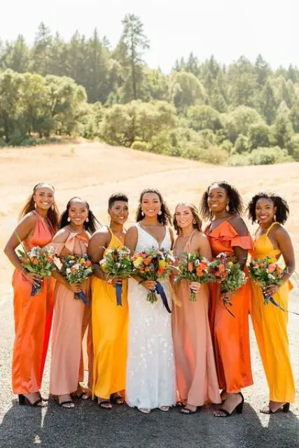 mismatching yellow, orange and pastel maxi bridesmaid dresses plus black shoes for a colorful summer wedding