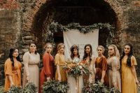 mismatching yellow, rust, nude and tan maxi bridesmaid dresses for a trendy and bold fall boho wedding