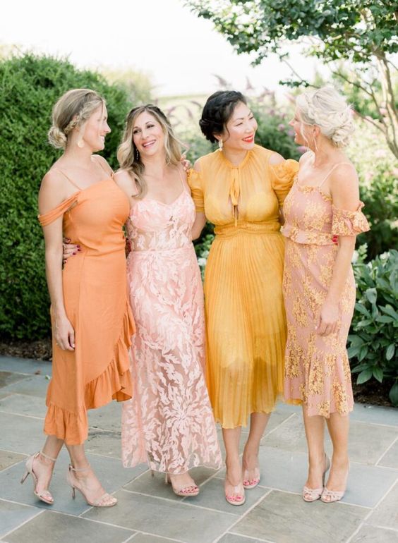 msiamtching blush, pink, orange and yellow midi bridesmaid dresses with various detailing and prints for a summer wedding