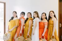 orange, yellow and mustard maxi bridesmaid dresses with mismatching necklines for a bold summer wedding