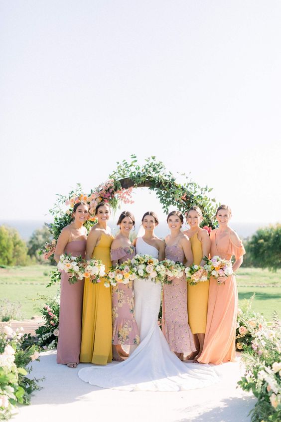 pastel maxi and midi bridesmaid dresses in coral, yellow and mauve for a sophisticated spring wedding