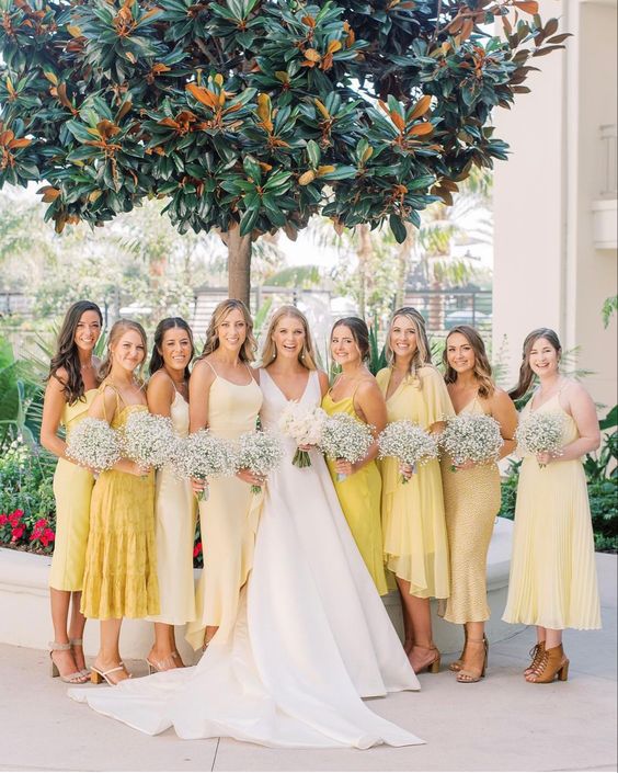 pretty mismatching midi pale yellow and yellow bridesmaid dresses are a chic idea for a spring or summer celebration
