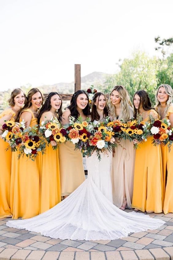 pretty strap maxi bridesmaid dresses in a bold shade of yellow are a great idea for a fall wedding
