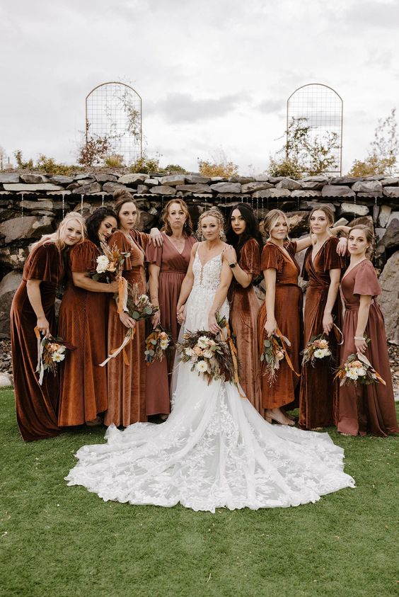 rust, brown and mauve mismatching maxi bridesmaid dresses for a formal fall or winter wedding