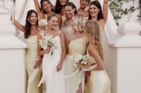 sophisticated pale yellow satin maxi bridesmaid dresses with slits are fantastic for a spring or summer wedding