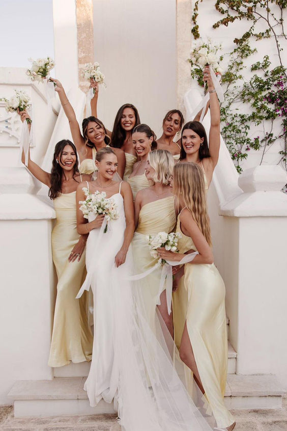 sophisticated pale yellow satin maxi bridesmaid dresses with slits are fantastic for a spring or summer wedding
