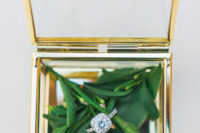 The ring box was a simple gilded glass one with greenery inside