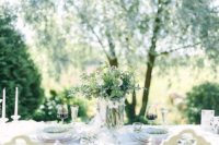 02 The wedding table setting was done in white, it’s simple, with greenery and white flowers