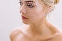 03 messy updo with a beaded birdcage veil