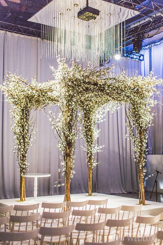 ceremony canopy made of branches and white flowers to make your winter nuptials solemn