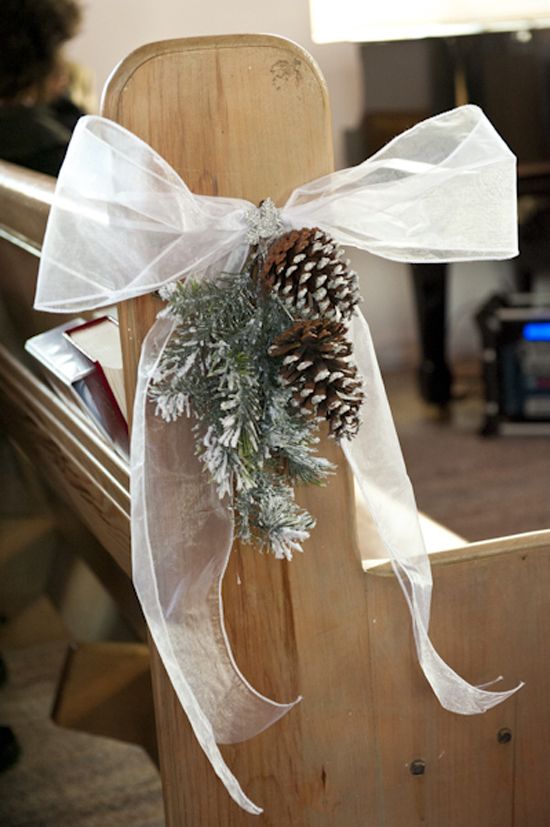pinecone and snowy fir branches with a bow for aisle decor