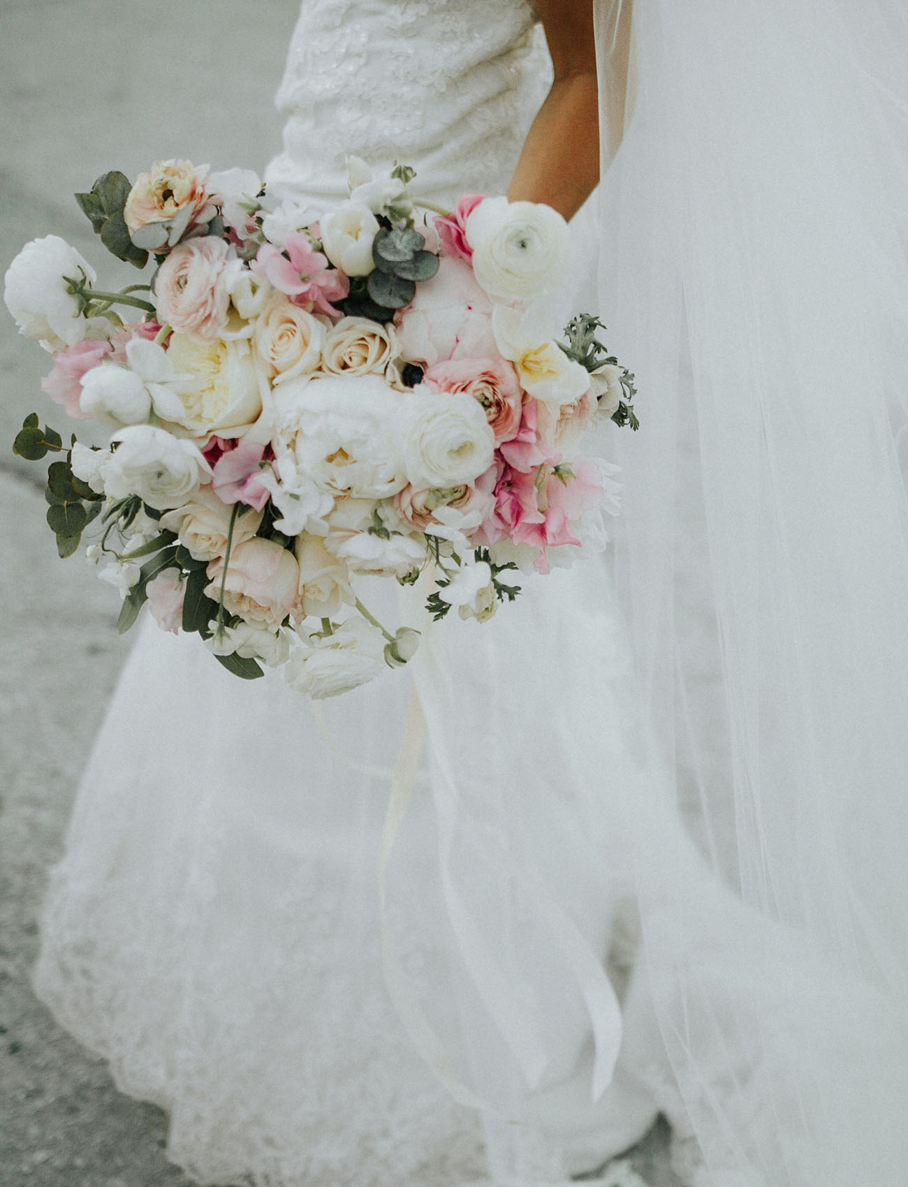 Lush, pastel bridal bouquet filled with peonies and ranunculus