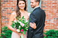 The bride was wearing a subtle blush gown with an embellished sash
