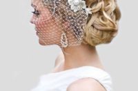 08 chic wavy updo with a bridal lace headpiece and a birdcage veil