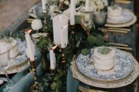 08 seaside wedding tablescape with eucalyptus, candles and blue glassware