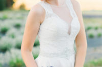 09 The wedding dress is a simple and elegant one, with an illusion neckline